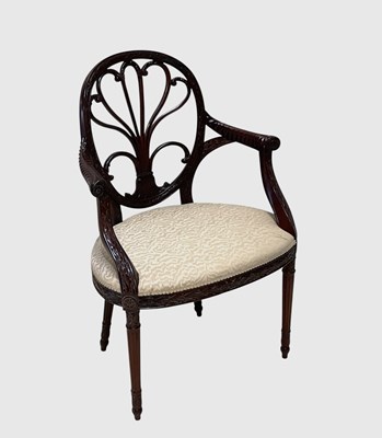 Lot 1014 - A reproduction carved mahogany open armchair...