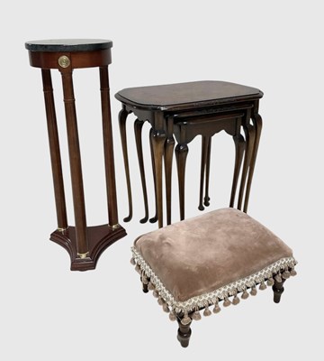 Lot 1041 - A walnut nest of three tables, with a carved...