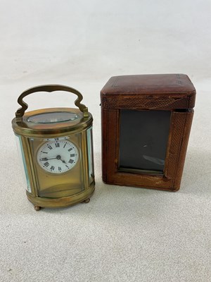 Lot 428 - A c 1900 cased French brass oval carriage...