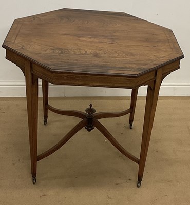 Lot 557 - A rosewood octagonal side table, raised on...