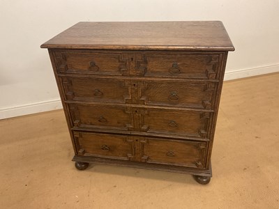 Lot 511 - An oak four drawer chest of drawers, with...