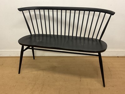 Lot 447 - ERCOL; a spindle back love seat in factory...