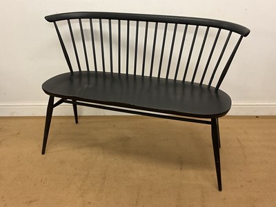 Lot 448 - ERCOL; a spindle back love seat in factory...