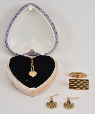 Lot 1204 - A 9ct yellow gold heart shaped pendant, on 9ct...