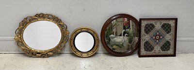 Lot 1202 - A wall mirror with convex glass, gilt framed...