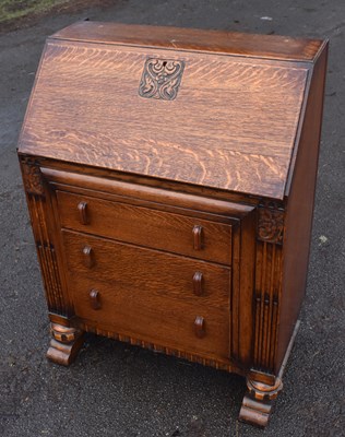 Lot 1704 - An early 20th century oak three drawer bureau