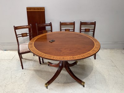 Lot 1104 - A circular mahogany extending dining table...