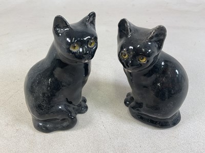 Lot 181 - WINSTANLEY POTTERY; a pair of black cat models...