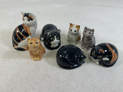 Lot 196 - QUAIL POTTERY; seven cats in various poses (7).