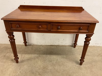 Lot 819 - A two drawer mahogany side table with turned...