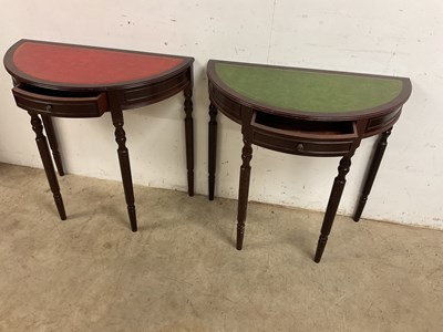 Lot 560 - A pair of reproduction demi-lune hall tables...