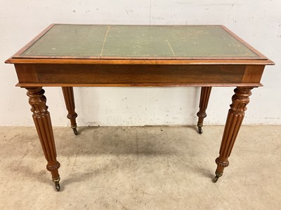 Lot 728 - A small leather topped desk with turned fluted...