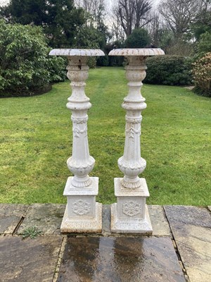 Lot 1224 - A pair of cast iron garden column planters,...
