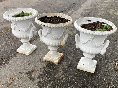Lot 1222 - Three cast iron garden planters modelled as...