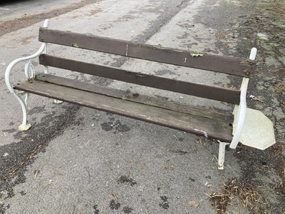 Lot 1240 - A cast iron and wood slatted garden bench, one...
