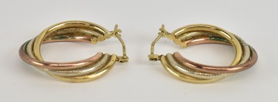 Lot 1373 - A pair of 9ct tricolour gold twist hoop...