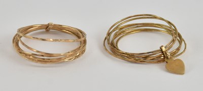 Lot 1259 - A pair of 14ct yellow gold multi-layered band...
