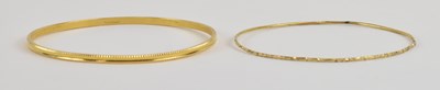 Lot 1410 - A yellow metal bangle, with indistinct...