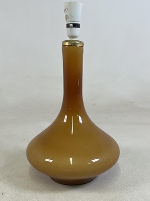 Lot 438 - A mid 20th century amber cased glass table...