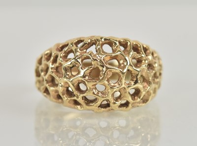 Lot 1257 - A 9ct yellow gold pierced textured dress ring,...