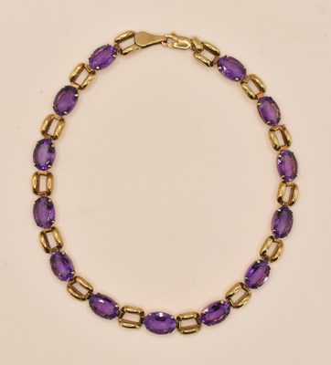 Lot 1466 - A 9ct yellow gold bracelet, with cut amethyst...