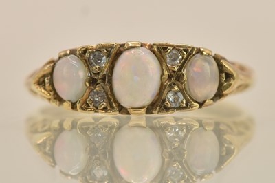 Lot 1312 - A 9ct yellow gold three opal and tiny diamond...
