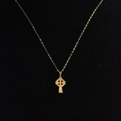Lot 1398 - A yellow gold cross pendant, on gold...