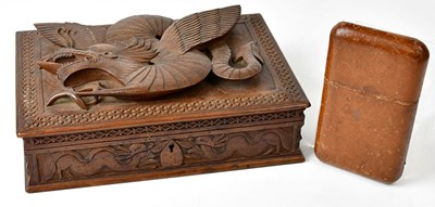 Lot 277 - A carved hardwood cigarette box depicting a...