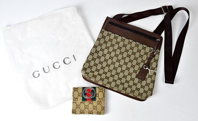 Lot 315 - GUCCI; a canvas and brown leather messenger...