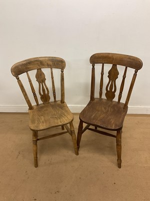 Lot 577 - A near pair of elm farmhouse chairs, one light...