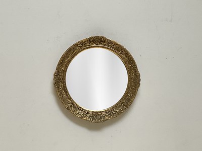 Lot 1040 - A giltwood and gesso circular wall mirror,...