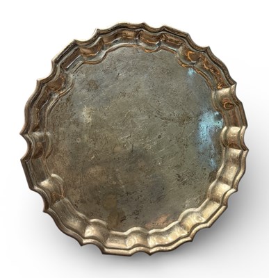 Lot 1133A - A white metal circular salver, with frilled...
