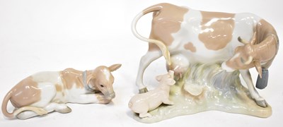 Lot 137 - LLADRO; a model of a cow with a suckling pig,...