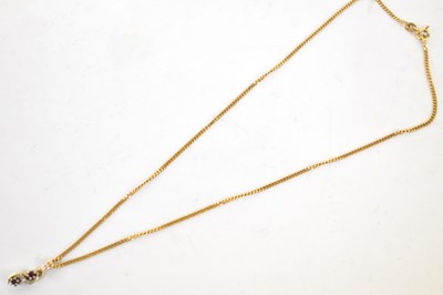 Lot 718 - A 9ct yellow gold S-shaped pendant set with...
