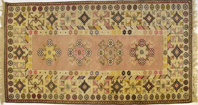 Lot 104 - A Middle Eastern rug, with central pink panel...