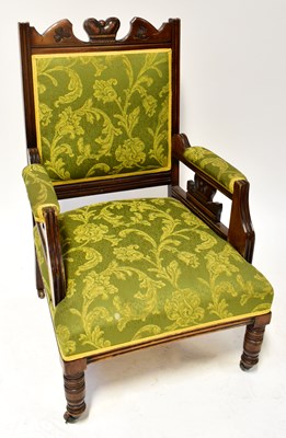 Lot 68 - An Edwardian carved walnut open armchair, the...