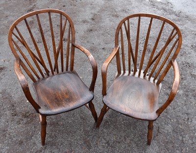 Lot 1758 - A pair of elm seated comb back elbow chairs.