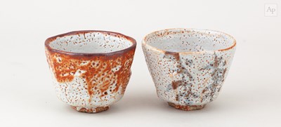 Lot 739 - A pair of faceted stoneware cups covered in...