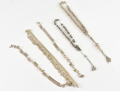Lot 1559 - A collection of three Eastern silver bracelets,...