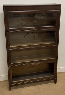 Lot 560 - GUNN; an oak four section bookcase with each...