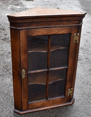 Lot 1745 - A small reproduction oak wall mounted corner cupboard