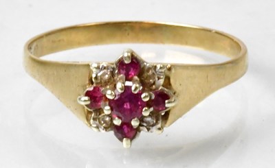 Lot 659 - A yellow metal ring set with a central ruby...