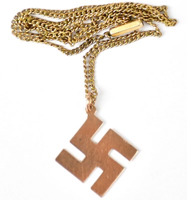 Lot 712 - A 9ct yellow gold swastika good luck symbol...