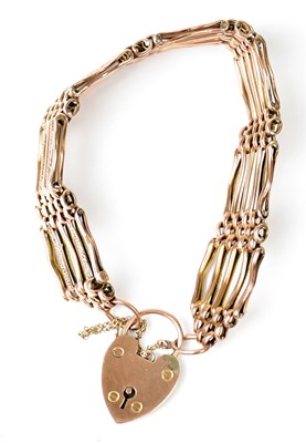 Lot 698 - A rose gold five-bar gate bracelet with heart...
