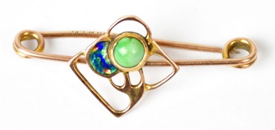 Lot 703 - A 9ct rose gold bar brooch set with a green...