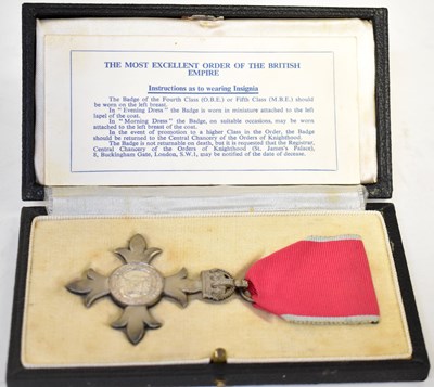 Lot 492 - A cased MBE medal, on pink ribbon and sterling...