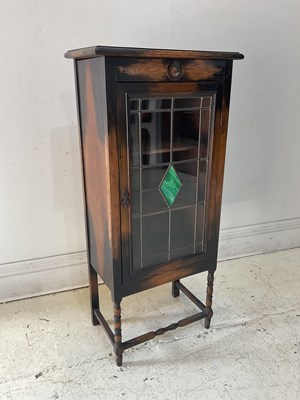 Lot 1177 - A reproduction oak music cabinet with glazed...