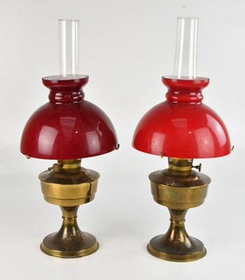 Lot 1321 - A near pair of brass paraffin lamps both with...