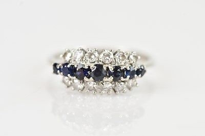 Lot 499 - An 18ct white gold diamond and sapphire set...