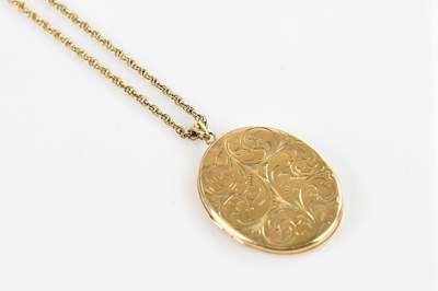 Lot 335 - A 9ct yellow gold oval locket, the front with...